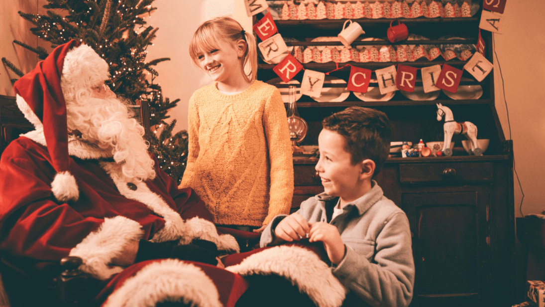 Two young children visiting Father Christmas at Ulster Folk Museum