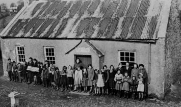 Teachers and pupils standing outside School