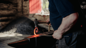 a blacksmith using a forge