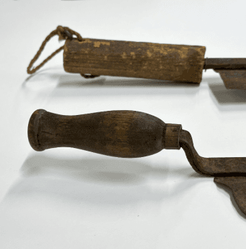 The handles of two thatching knives showing the variation of design. One is long and straight, the other shorter and curved.