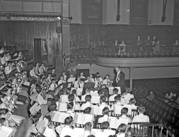 A wide view of a children's orchestra. The image is in black and white.