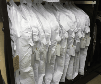 A line of clothes in white covers.