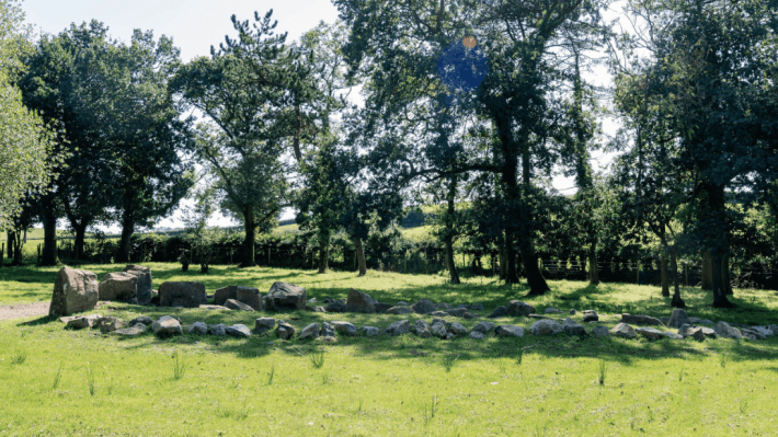 Side angle photo of the Ballintaggart Court Tomb on a sunny day