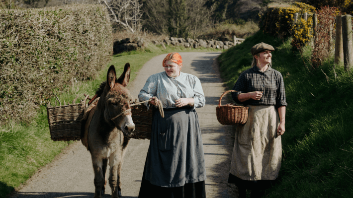 two women walking beside a donkey at ulster folk museum