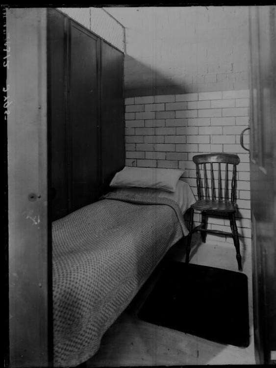 Carrick House. Interior, black and white photograph of a single bed and wooden chair