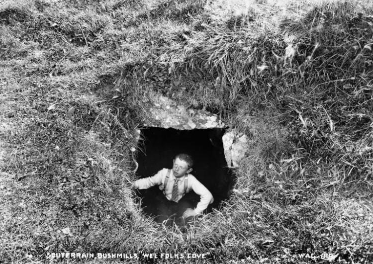 A boy looks out of a souterrain.