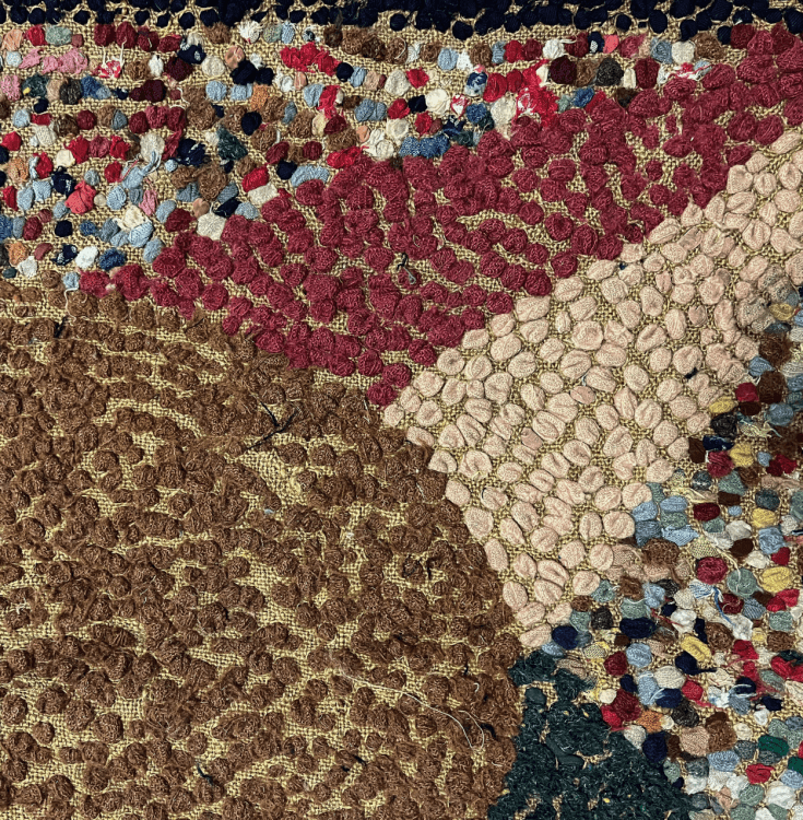 The back of a colourful rug, showing the details of the fabrics.