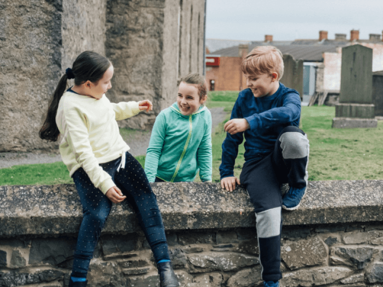 Three kids playing on a wall, Ulster Folk Museum